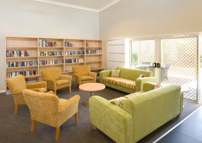 a living room filled with furniture and a book shelf