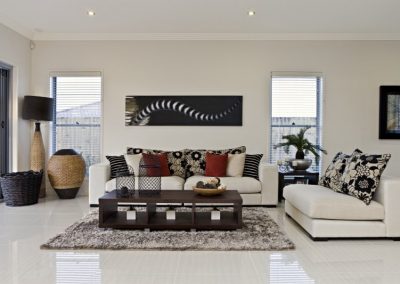 a living room filled with furniture and a large window.